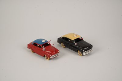 two toy cars that are sitting next to each other