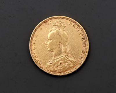 gros plan d'une pièce d'or sur une surface noire
