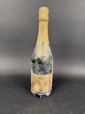 a bottle of champagne on a black table with a gray background