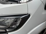 a close up of a car ' s headlight on a street