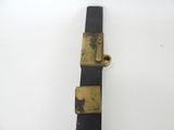 a black and gold belt on a white surface