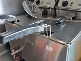 two deep fryers that are sitting in a kitchen