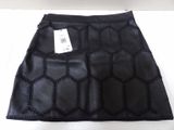 the skirt is made of black leather and has a geometric pattern on it