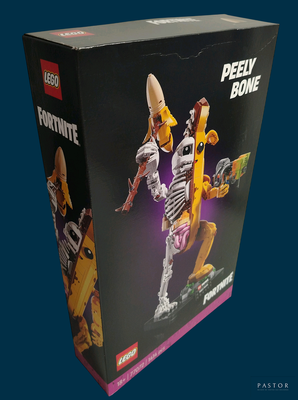 une boîte contenant une figurine Lego représentant un homme tenant une banane