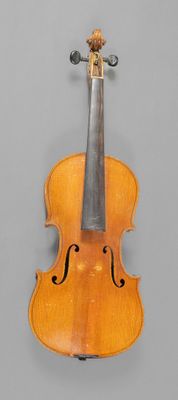 an old violin with a bow on a gray background