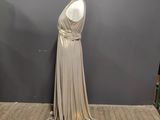 a mannequin in the middle of a dress on a wooden floor