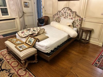 a bed that is in a room with a wooden floor