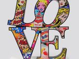 a close up of a sculpture of the word love on a white surface