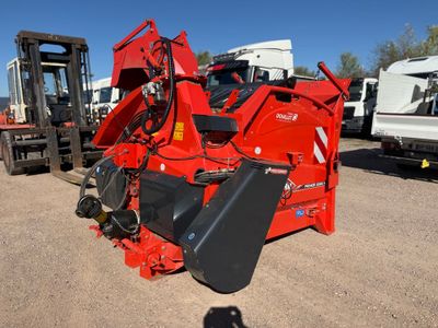 an image of a red tractor with a fork attachment
