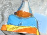 une figurine en céramique représentant un chat allongé sur un lit