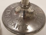 a silver candle that is on top of a table