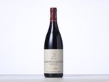 the bottle of red wine is sitting on the table