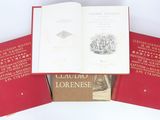three red books sitting on top of each other on a white surface