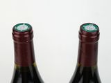 two bottles of wine sitting next to each other on a table