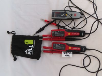 three electrical tools are laying on a white surface with a black bag