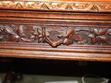 a close up of a wooden table with carvings on it