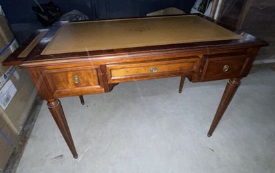 a wooden desk with two drawers on top of it