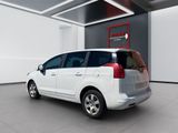 the white van is parked in a large room with a red sign on the wall
