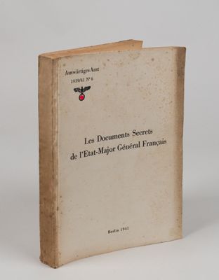 an old book sitting on top of a table next to a white wall