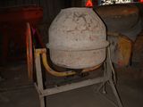 a cement mixer sitting in the middle of a room