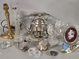 a silver tea pot and a silver tea pot and a gold tea pot and a silver tea pot and a gold tea pot and a glass vase