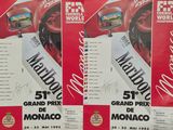 three posters for the monaco grand prix are on display in a store