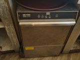 an image of a dishwasher in a dirty kitchen