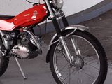 a red motorcycle that is parked in a garage
