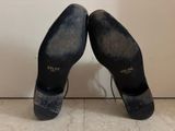 pair of women ' s black sued shoes with laces on them
