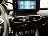 a car dashboard with a monitor and steering wheel
