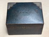 a small black box with writing on it sitting on a table