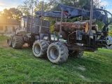a tractor with a log loader on the back of it
