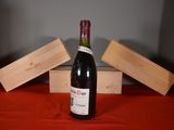 a bottle of wine sitting on a table next to wooden blocks