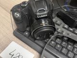 a camera on a desk next to a keyboard and a monitor
