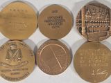 four different types of coins are shown on a white surface