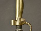 a close up of a gold colored sword with a metal handle