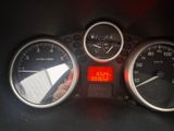 a close up of a speedometer and gauges on a car