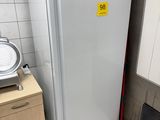 a white refrigerator in a small kitchen next to a stove