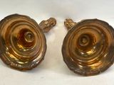 pair of antique brass candlesticks on a white background