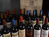 many bottles of wine that are sitting on a table
