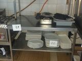 a kitchen with a stove, sink, and shelves with pots and pans on it