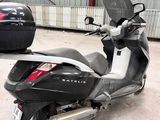 a black and silver scooter parked in front of a building