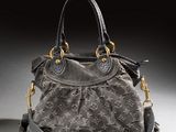 a close up of a louis vuitton bag on a white surface