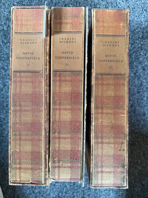 three books sitting on top of a blue carpet next to each other
