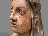 an old statue of a woman with a veil on her head