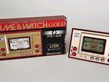a small electronic game in a box next to a smaller electronic game