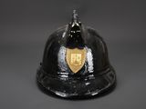 an old fireman ' s helmet with a shield on top of it