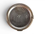 a silver clock on a white surface with a white background