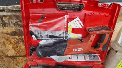 a red tool case with tools in it on the ground