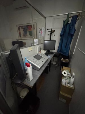 a desk with a computer and a monitor in a room